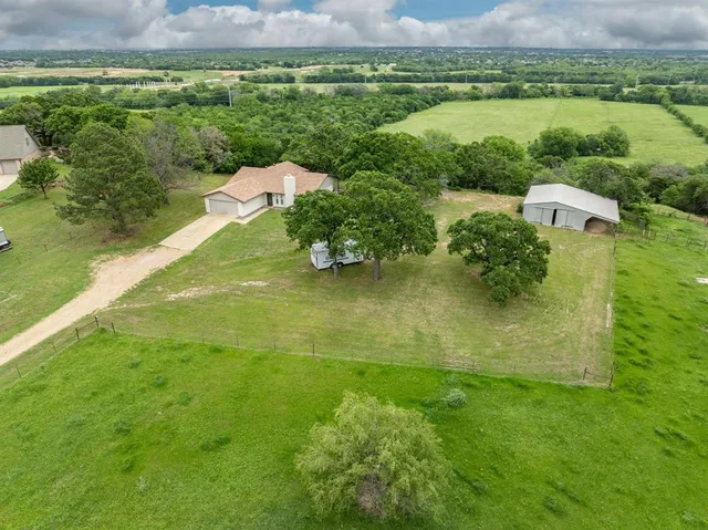 an aerial view of a houses with outdoor space and a lake view