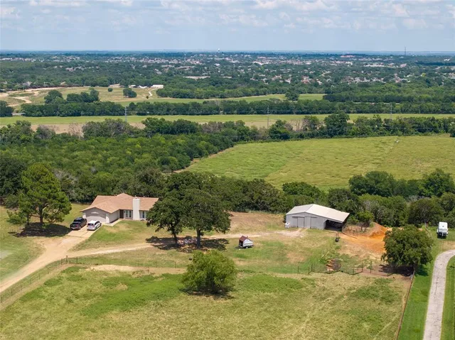 an aerial view of a house with a lake view