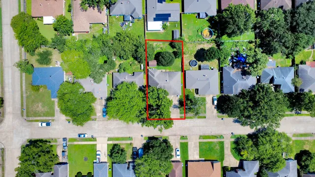 an aerial view of a house with a yard and garden