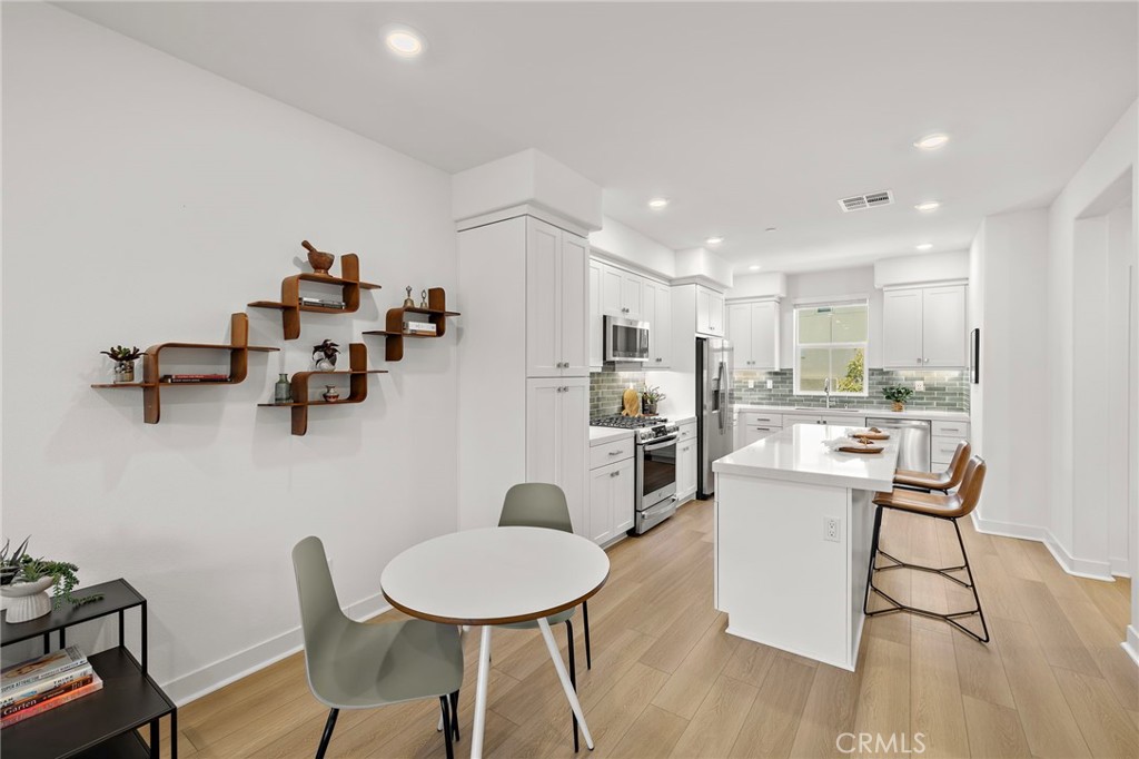 61 Wheelbarrow Road Rancho Mission Viejo, CA 92694 - Photo 6 of 74 a room with stainless steel appliances kitchen island granite countertop furniture and a kitchen view