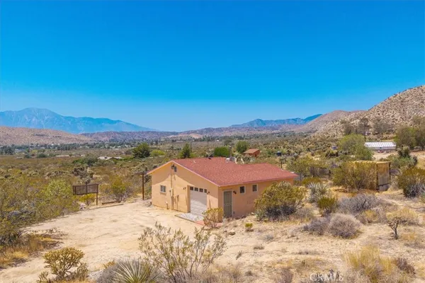 a view of a house with a mountain yard