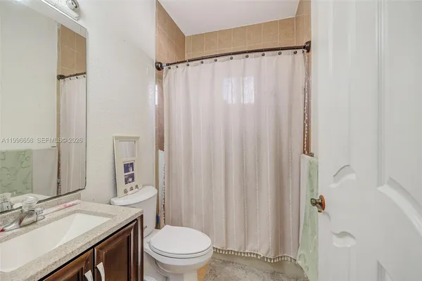 a bedroom with a bed and a mirror