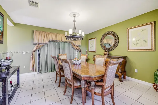 a dining room with furniture and chandelier