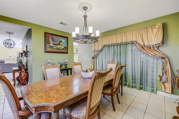 a dining room with furniture and window