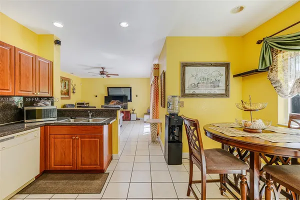a open kitchen with stainless steel appliances granite countertop a stove a sink dishwasher and cabinets with wooden floor