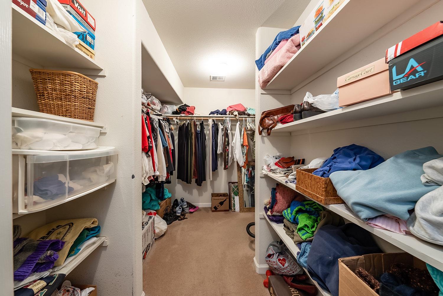 16601 La Canada Road Madera, CA 93636 - Photo 22 of 40 a view of walk in closet with clothes and shoes