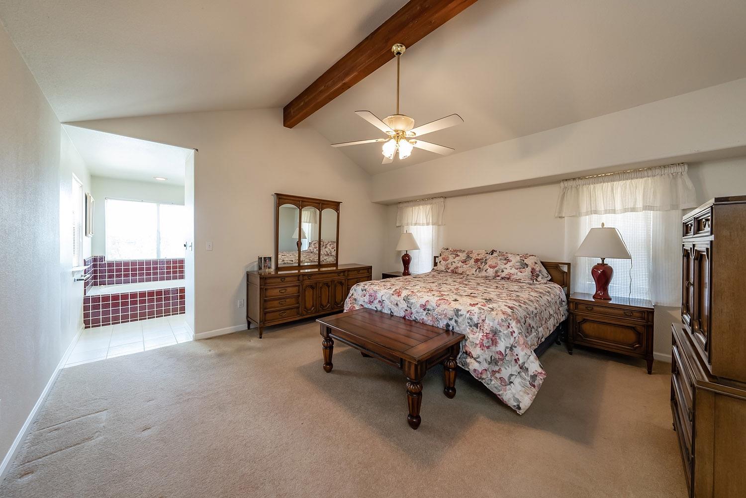 16601 La Canada Road Madera, CA 93636 - Photo 24 of 40 a spacious bedroom with a bed a chandelier and dresser