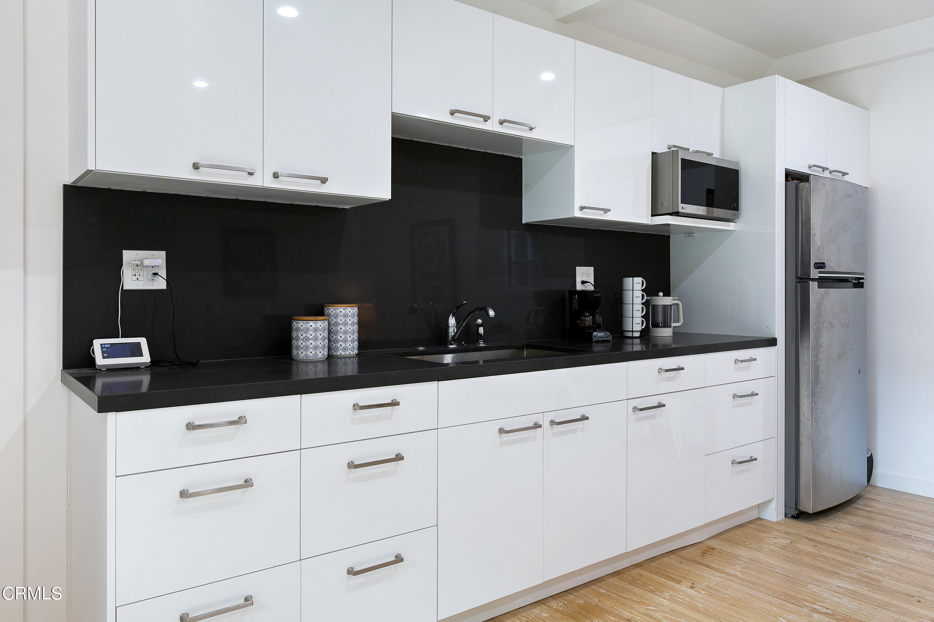 1665 Braeburn Road Altadena, CA 91001 - Photo 23 of 33 a kitchen with granite countertop white cabinets and stainless steel appliances