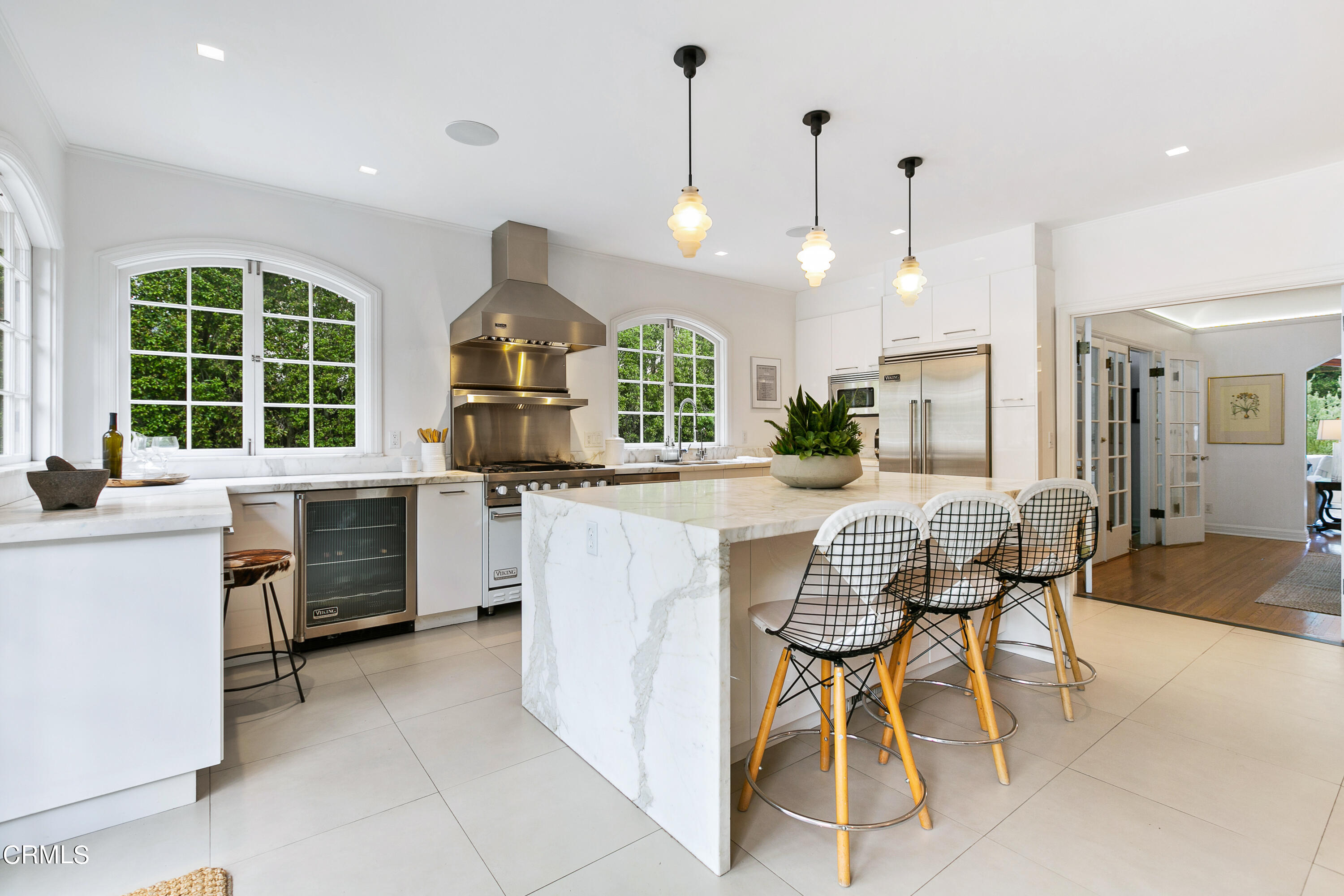 1665 Braeburn Road Altadena, CA 91001 - Photo 9 of 33 a kitchen with stainless steel appliances kitchen island granite countertop a stove a sink a dining table and chairs