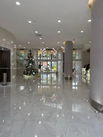 a view of a lobby with black carpet