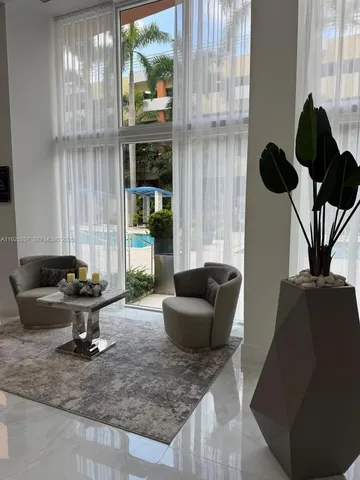 a view of a refrigerator in kitchen and an empty room
