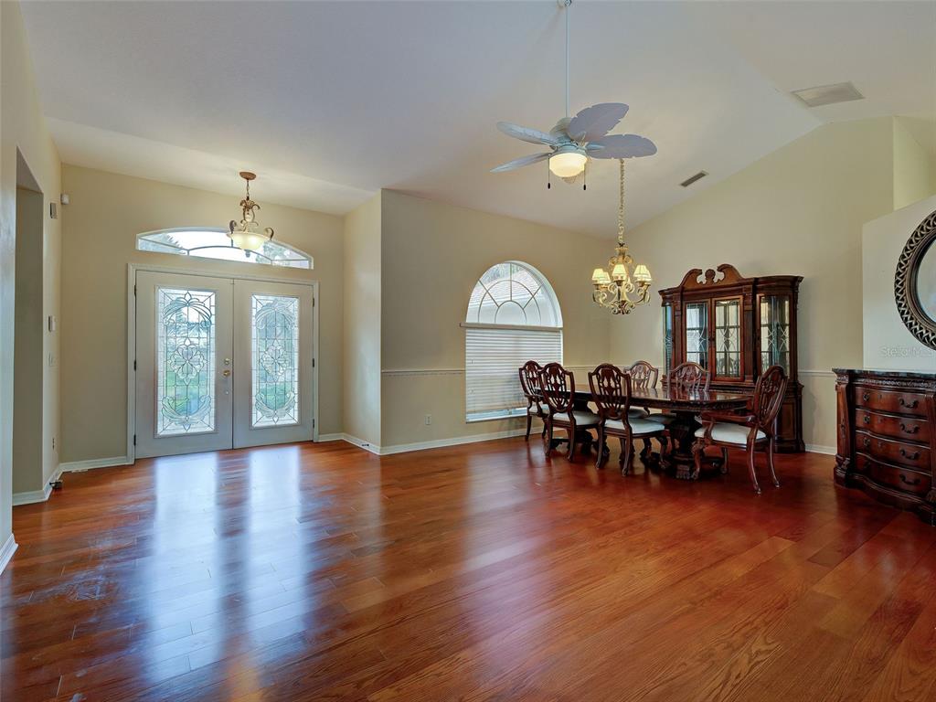 6265 Pheasant Road Venice, FL 34293 - Photo 24 of 70 a view of a dining room with furniture and wooden floor