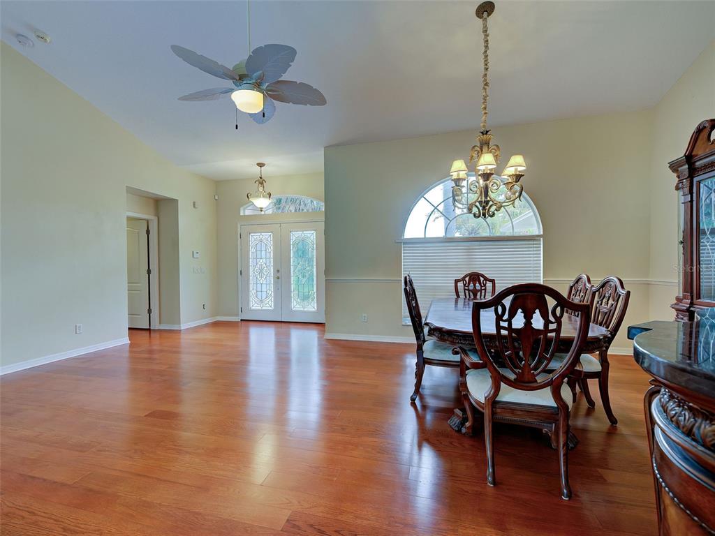 6265 Pheasant Road Venice, FL 34293 - Photo 25 of 70 a view of a dining room with furniture wooden floor and chandelier