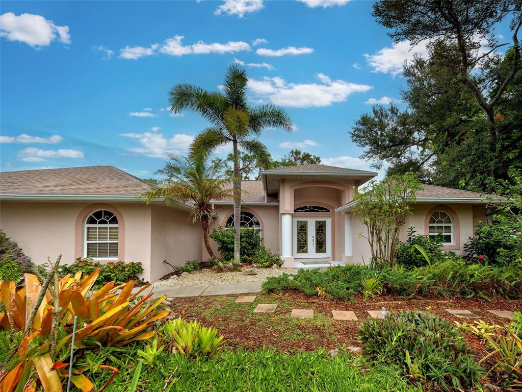 6265 Pheasant Road Venice, FL 34293 - Photo 5 of 70 a front view of a house with a yard and potted plants