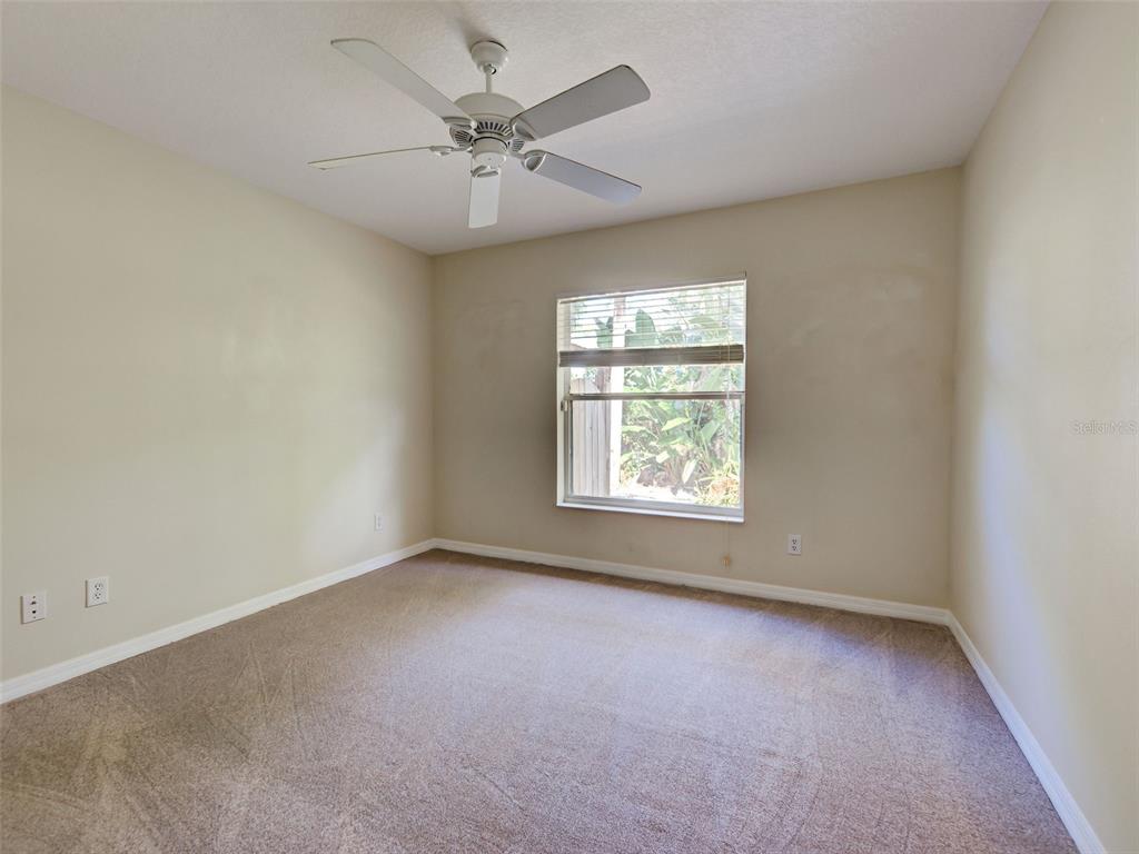 6265 Pheasant Road Venice, FL 34293 - Photo 64 of 70 an empty room with a window and a fan