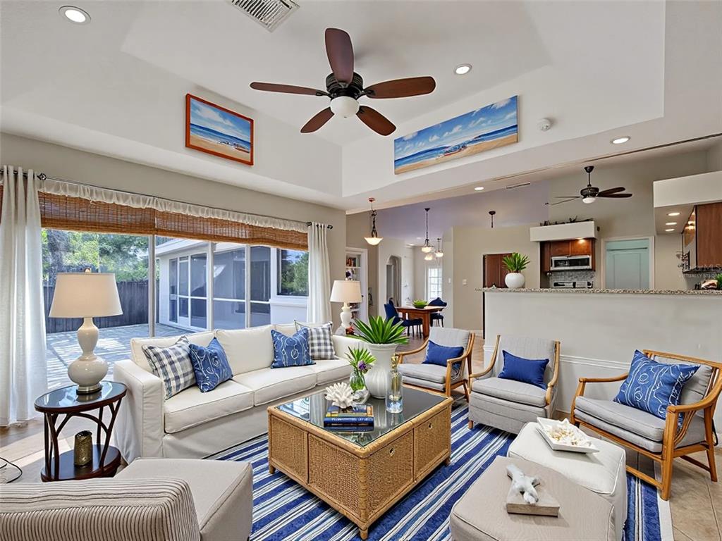 6265 Pheasant Road Venice, FL 34293 - Photo 69 of 70 a living room with furniture a ceiling fan and a large window