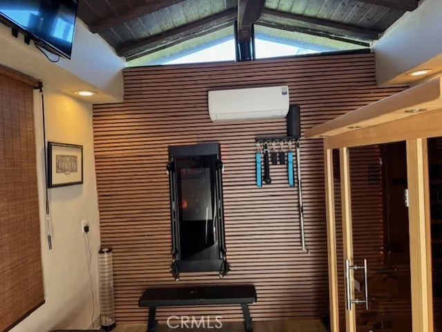 a view of a house with a door and a tree