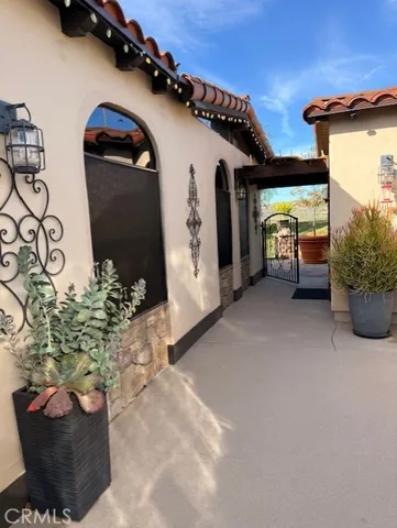a view of a porch with furniture and floor to ceiling window