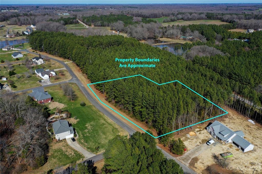 an aerial view of a residential houses with outdoor space and street view