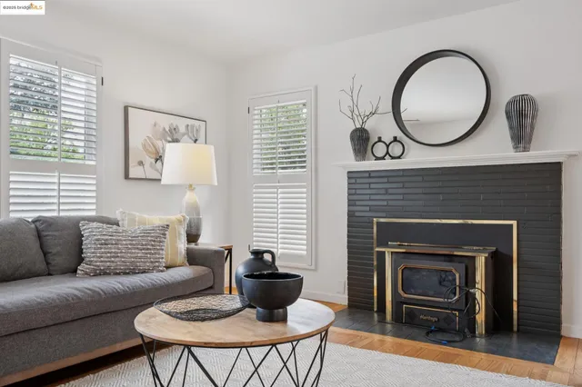 a living room with furniture a rug and a table
