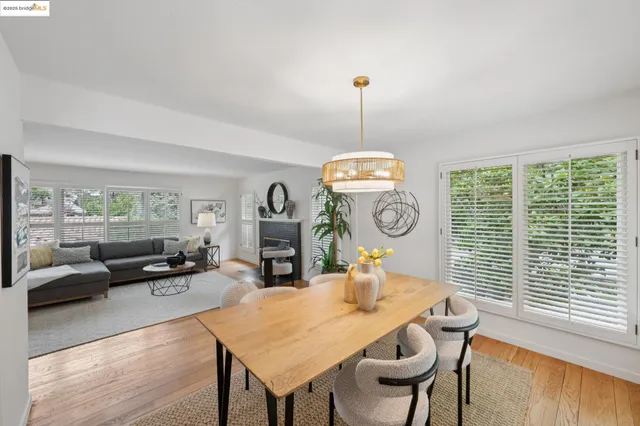 a kitchen with a table chairs and wooden floor