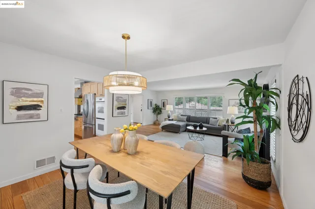 a kitchen with stainless steel appliances granite countertop sink stove and wooden floor