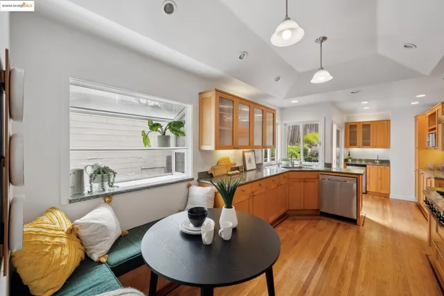 a large kitchen with kitchen island granite countertop a large window a sink and stainless steel appliances