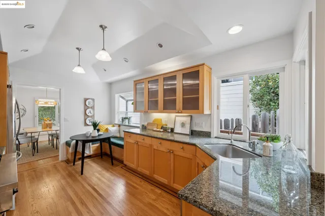 a kitchen with large windows and refrigerator