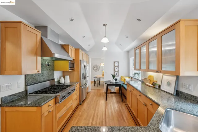 a kitchen with granite countertop a sink a counter top and a potted plant