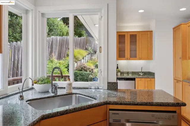 a kitchen with granite countertop a refrigerator stove and microwave