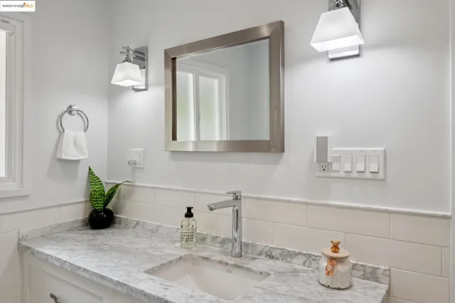 a living room with furniture a rug and kitchen view