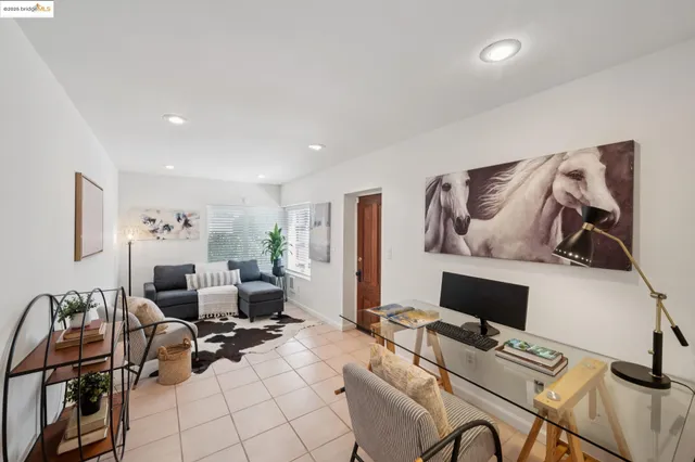 a view of a patio with furniture and a garden