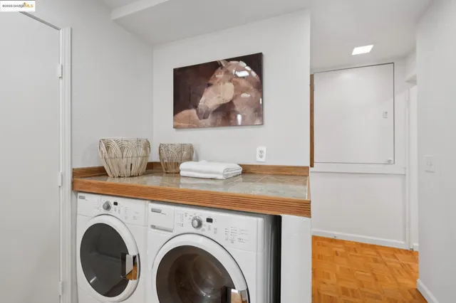 a view of a chairs and table in the back yard of the house and a fence