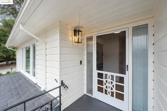 a living room with furniture a fireplace and paintings on the wall