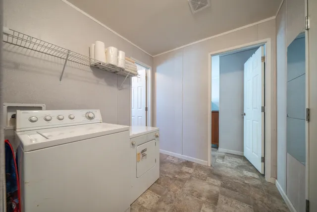 a view of storage and utility room with washer and dryer