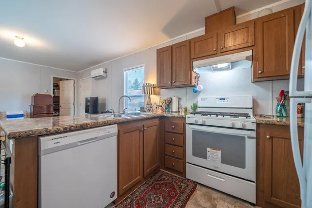 a kitchen with stainless steel appliances granite countertop a stove and a refrigerator