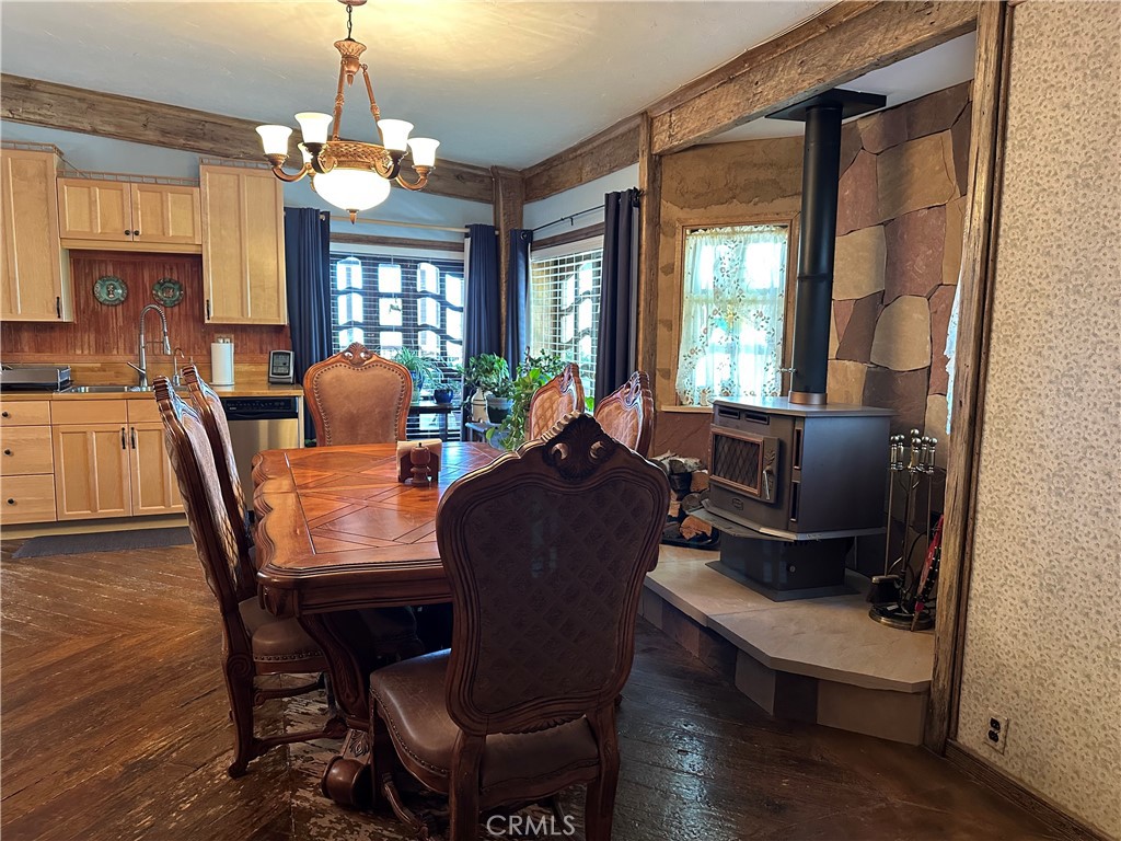 57260 Ramsey Road Anza, CA 92539 - Photo 20 of 44 a view of a dining room with furniture a chandelier and wooden floor