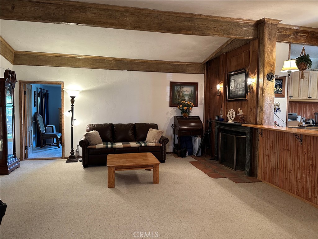 57260 Ramsey Road Anza, CA 92539 - Photo 21 of 44 a living room with furniture a kitchen view and a refrigerator