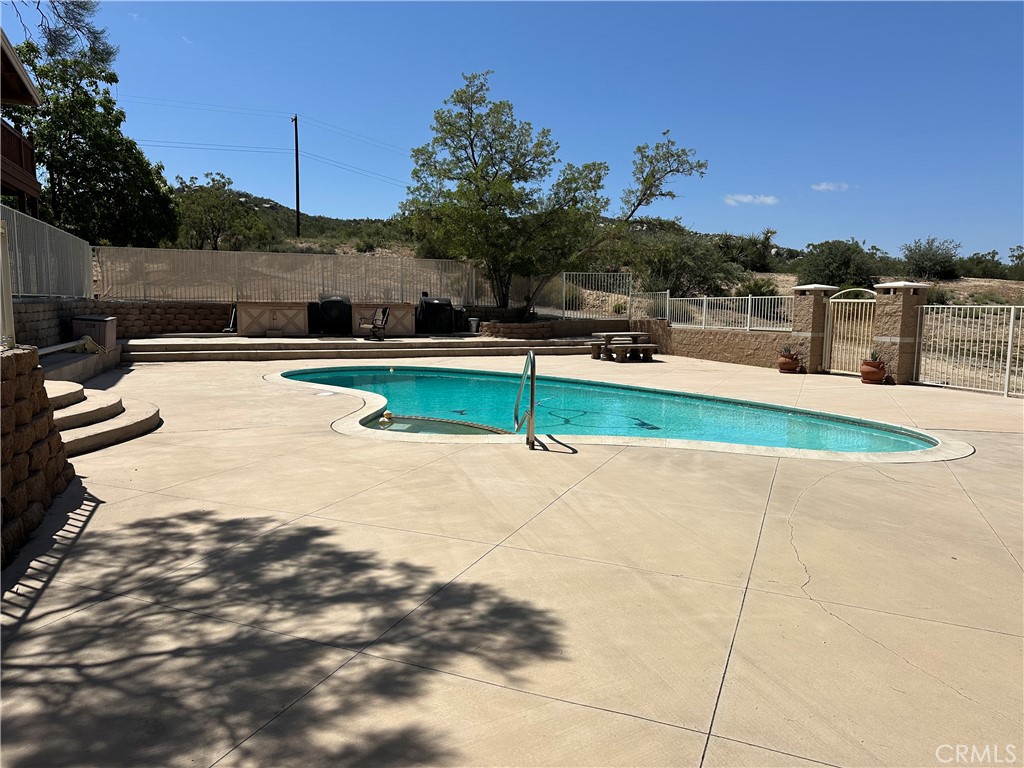 57260 Ramsey Road Anza, CA 92539 - Photo 42 of 44 a view of a swimming pool with a lounge chairs