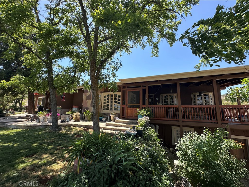 57260 Ramsey Road Anza, CA 92539 - Photo 5 of 44 a front view of a house with garden and patio