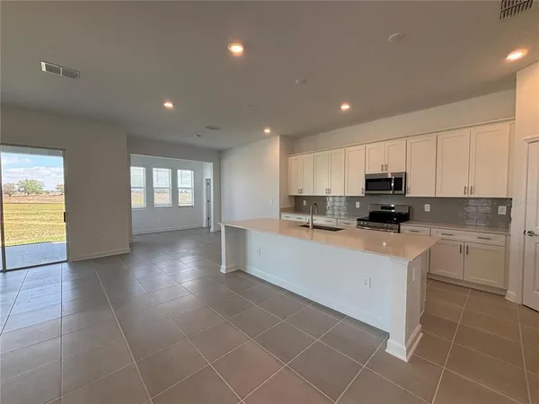 a kitchen with stainless steel appliances granite countertop a refrigerator sink and cabinets