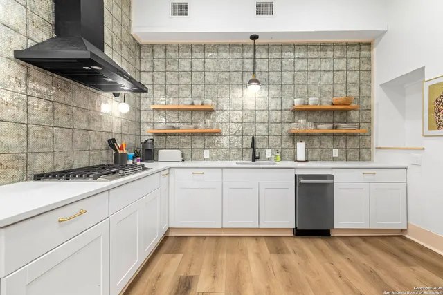 a kitchen with granite countertop white cabinets and white appliances