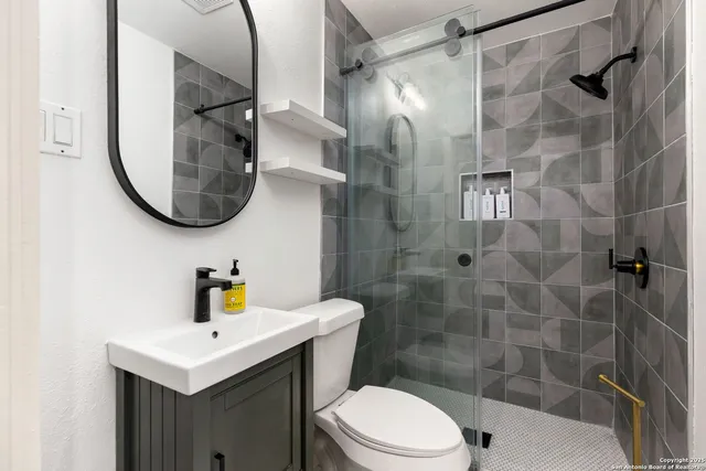 a bathroom with a sink toilet and shower