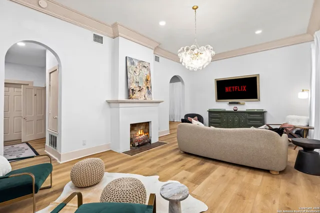 a living room with furniture a fireplace and a flat screen tv