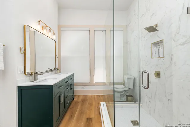 a bathroom with a double vanity sink and mirror