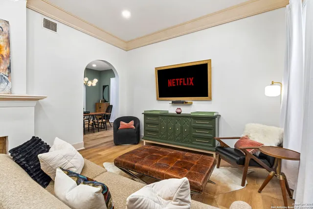 a living room with furniture and a flat screen tv