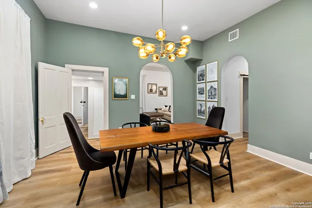 a view of a dining room with furniture and chandelier