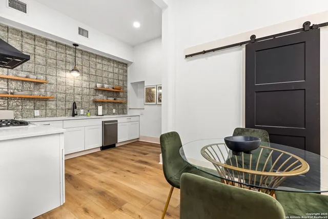 a kitchen with a refrigerator and a sink