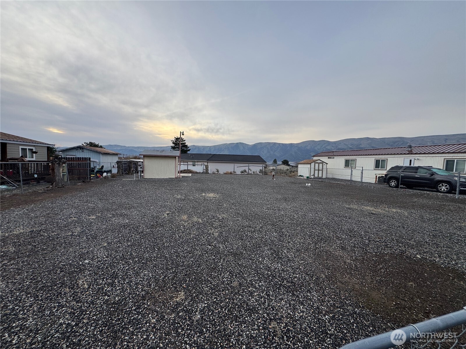 606 Edgewater Way Southwest Mattawa, WA 99349 - Photo 2 of 4 a view of a yard with a car parked
