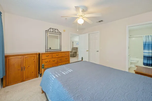 a bedroom with a bed and a dresser